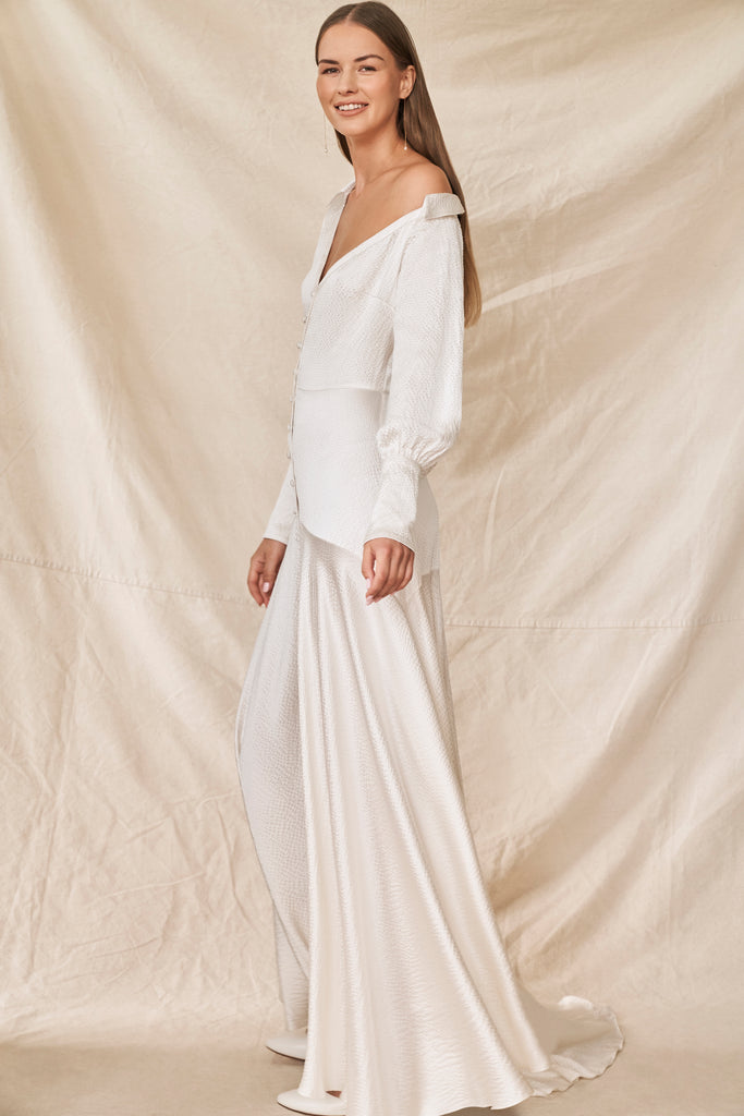 Woman wearing long sleeve silk wedding dress side view