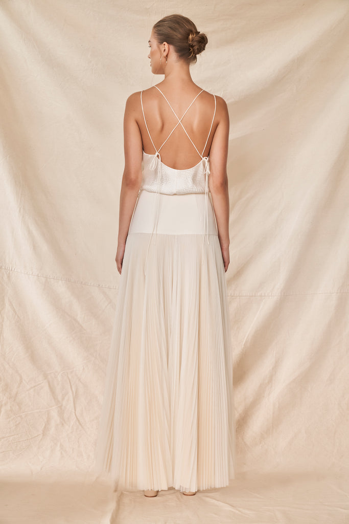 Woman wearing two piece wedding dress with silk satin cami and pleated tulle skirt back view