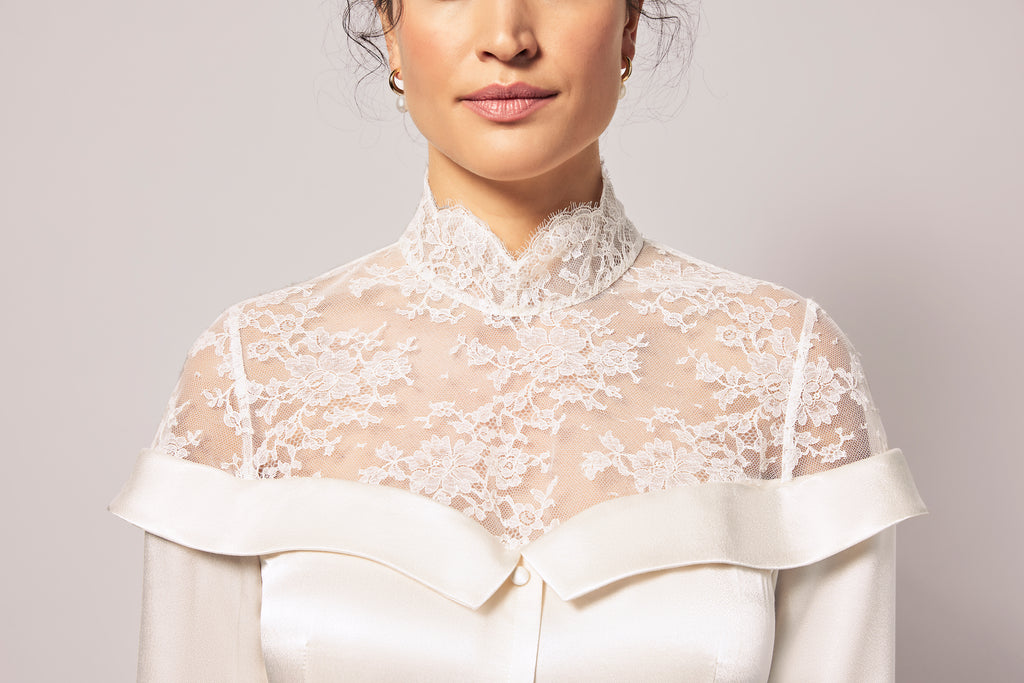 Woman wearing off-white silk charmeuse bridal shirt dress with lace collar