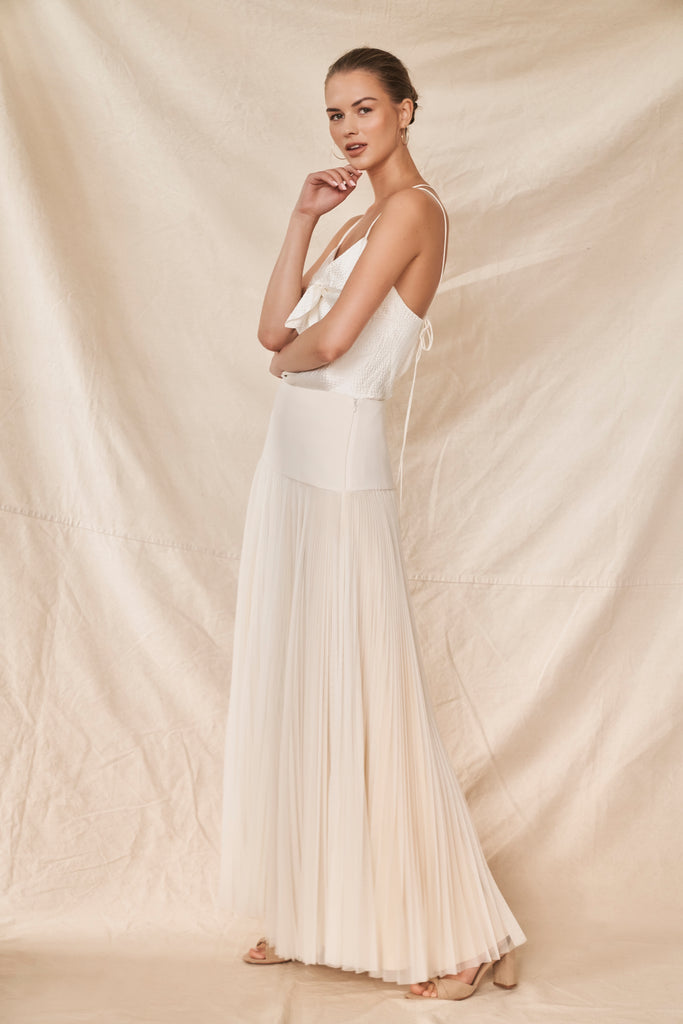 Woman wearing two piece wedding dress with silk satin cami and pleated tulle skirt side view