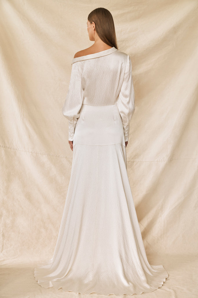 Woman wearing long sleeve silk wedding dress back view