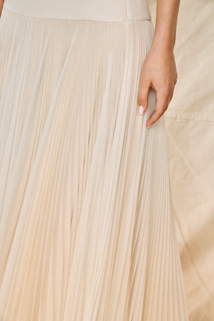 Woman wearing ivory pleated bridal skirt